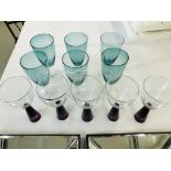 A PAIR OF MODERN DESIGNER PRINTS IN MIRRORED FRAMES PLUS A SET OF SIX GREEN GLASS STEMMED WINES AND