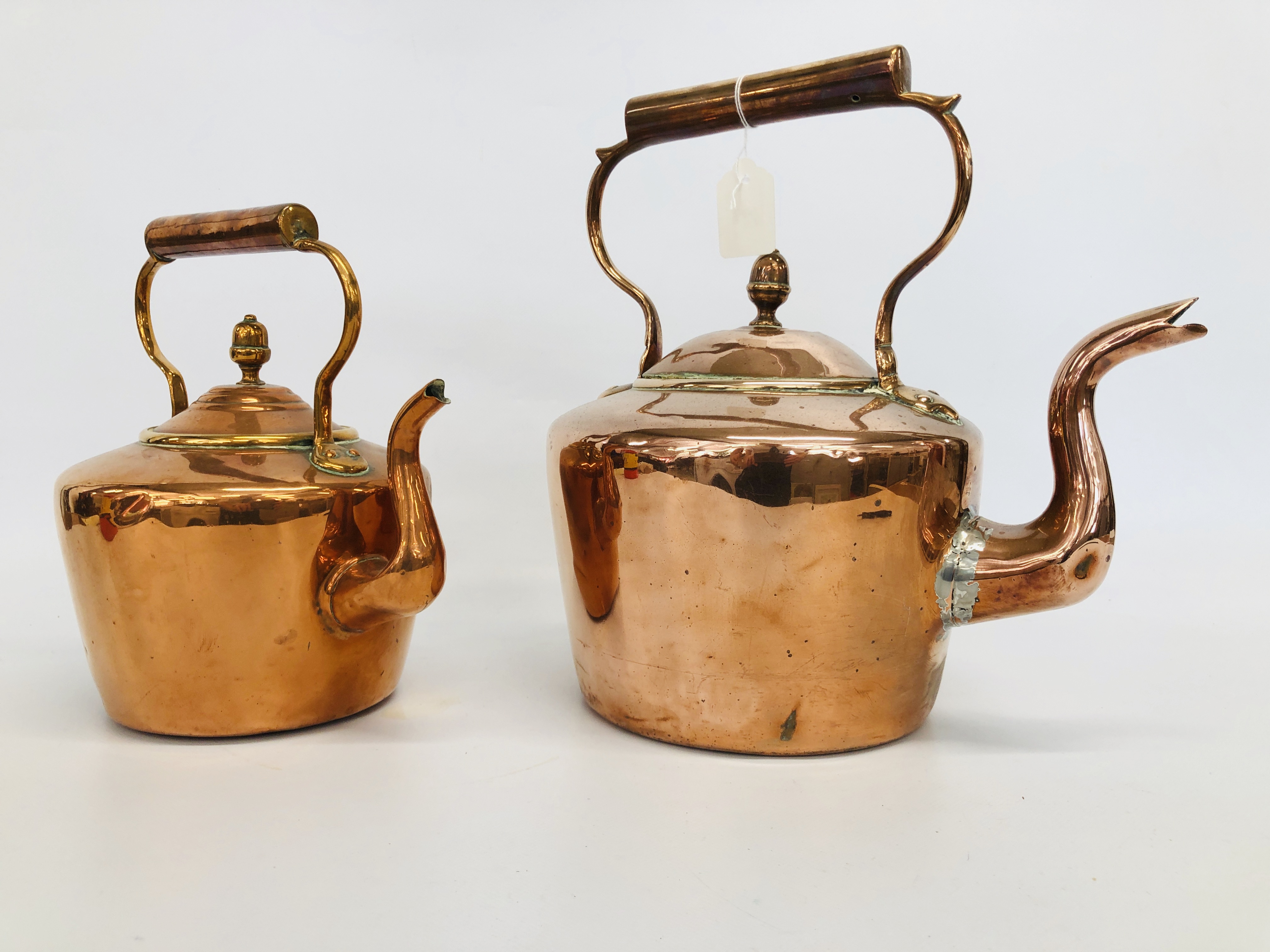 A LARGE COPPER KETTLE AND ONE SMALLER