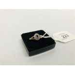 LADIES RING MARKED 375 WITH CENTRAL PURPLE STONE SURROUNDED BY SMALL CLEAR STONES
