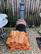 A CHIMINEA AND FOUR BAGS OF LOGS