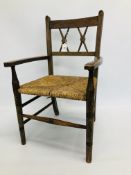 A VINTAGE CHILD'S ELBOW CHAIR WITH RUSH SEAT