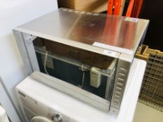 A TESCO STAINLESS STEEL COMBINATION MICROWAVE OVEN MODEL MC2514 - SOLD AS SEEN