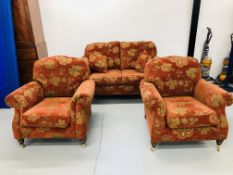 A RED PATTERNED TRADITIONAL COTTAGE THREE PIECE SUITE