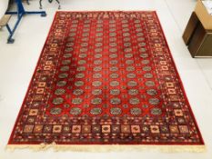 A RED PATTERNED CARPET SQUARE 3.5M X 2.