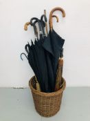 A WICKER BASKET CONTAINING A COLLECTION OF UMBRELLAS TO INCLUDE WHANGEE HANDLED AND TWO ORIENTAL