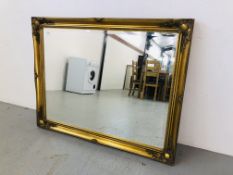 LARGE BEVEL PLATE WALL MIRROR WITH SCROLL DESIGN ON A GILT FINISH BACKGROUND
