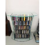 MODERN DESIGNER GLASS CD/DVD STORAGE SHELF ALONG WITH LARGE QTY MIXED CD'S