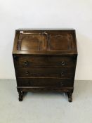 A REPRODUCTION OAK FINISH THREE DRAWER WRITING BUREAU WITH FITTED INTERIOR,