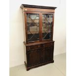 A REPRODUCTION MAHOGANY FINISH ASTRAGAL GLAZED BOOKCASE STANDING ON TWO DRAWER CABINET BASE -