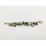 A SILVER CHARM BRACELET CONTAINING THIRTY VARIOUS CHARMS