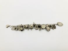 A SILVER CHARM BRACELET CONTAINING THIRTY VARIOUS CHARMS