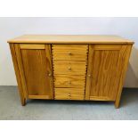 A HONEY PINE DRESSER BASE THE FOUR CENTRAL DRAWERS FLANKED BY TWO CABINETS LENGTH 47 INCH,