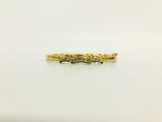 A STONE SET HINGED BANGLE MARKED 18CT