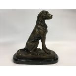 A MODERN BRONZE OF A SEATED LABRADOR ON