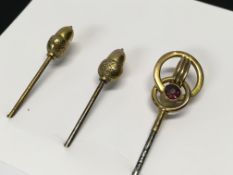 TWO 9CT. GOLD ACORN HAT PINS AND ONE OTH