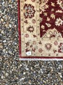 A C20TH FARHAN RUNNER WITH RED FIELD AND