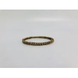 A YELLOW METAL ROPE DESIGN BANGLE MARKED