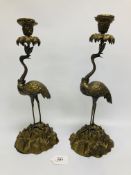 A PAIR OF GILT METAL CRANE CANDLESTICKS