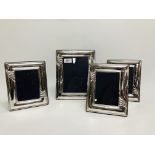 A SET OF FOUR SILVER PICTURE FRAMES WITH