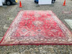 A LARGE RED PATTERNED CARPET - VERY POOR CONDITION 130 INCH X 184 INCH