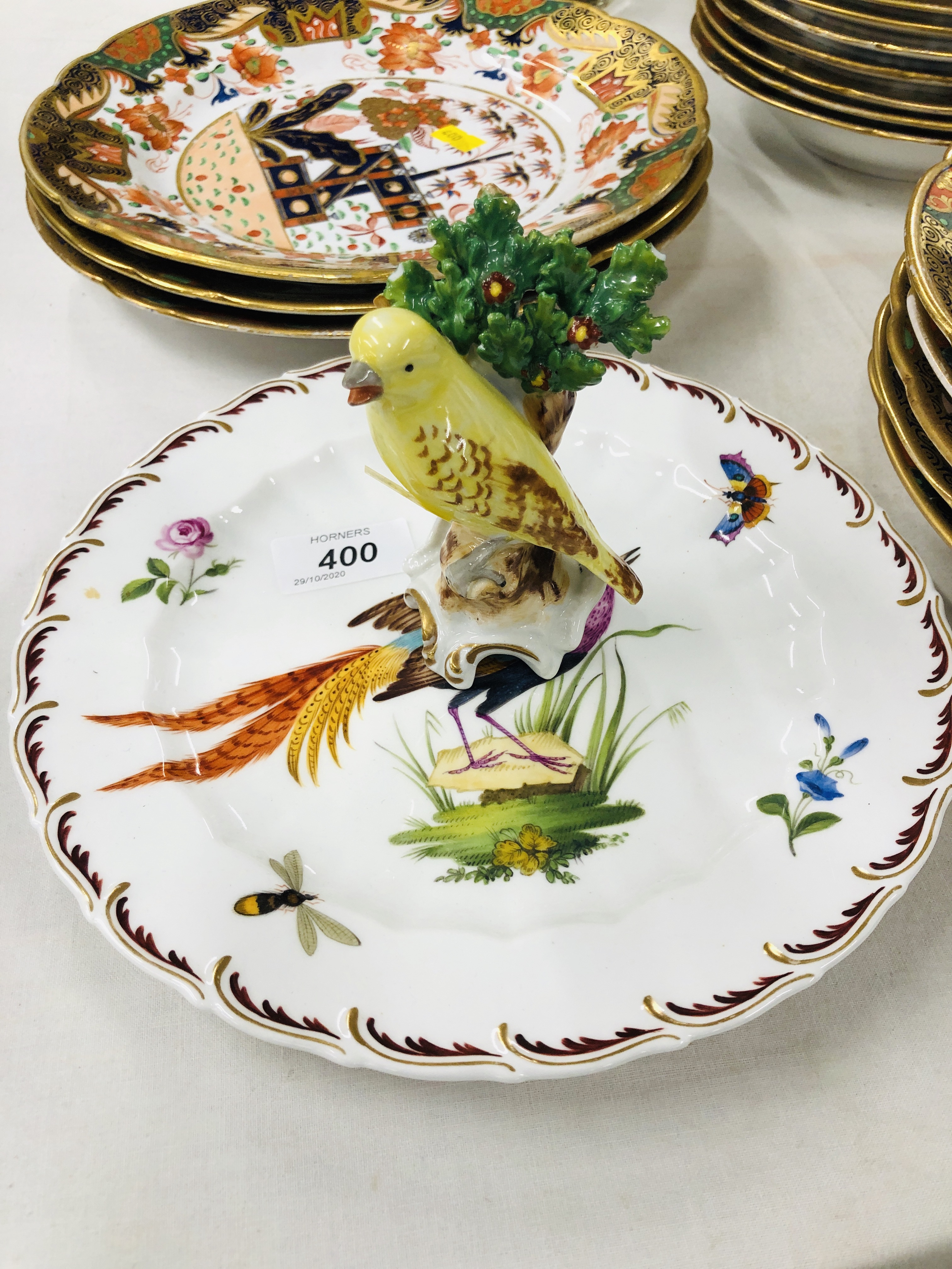 A PLATE DECORATED WITH AN EXOTIC BIRD BEARING GOLD ANCHOR MARK,