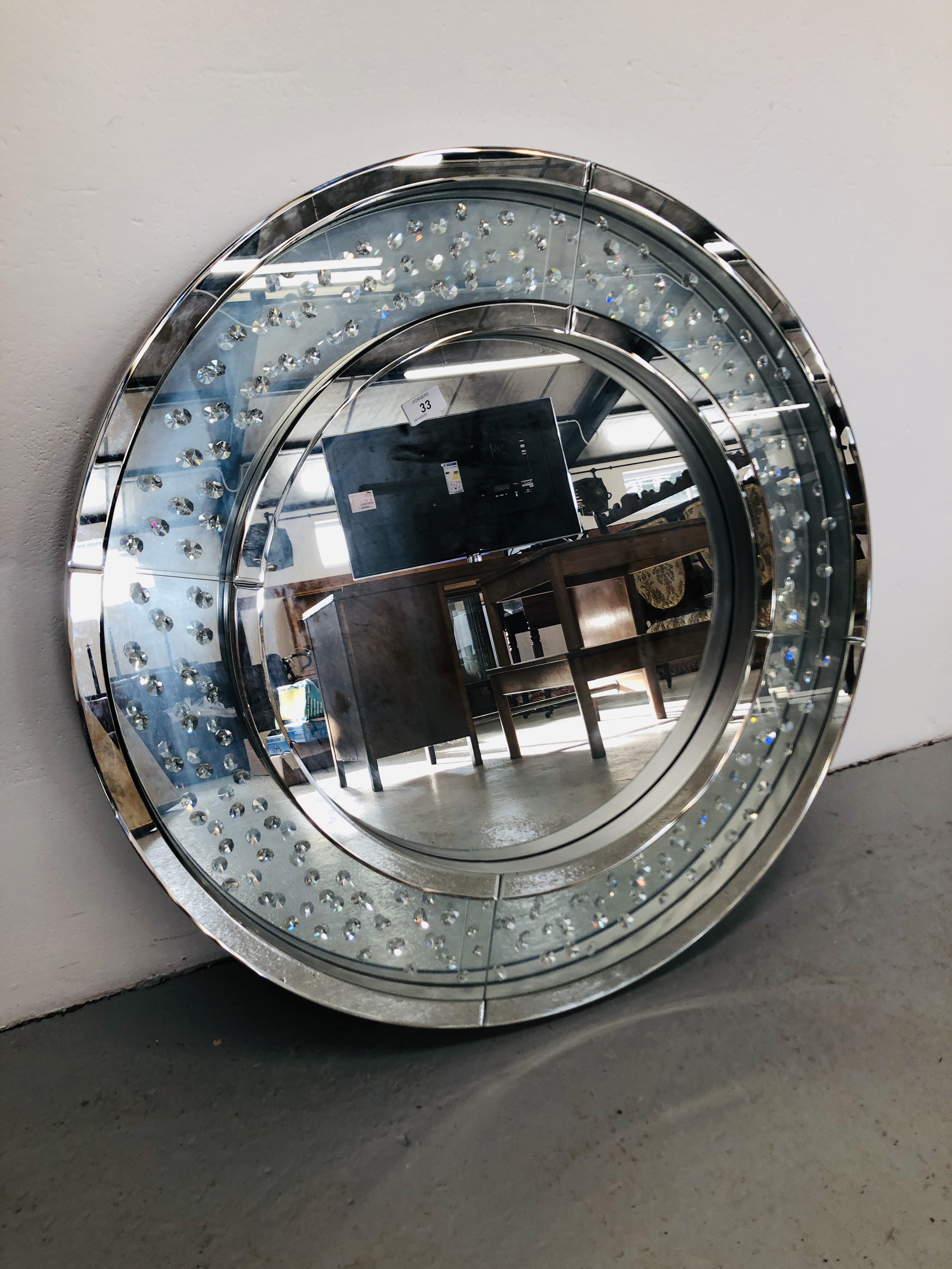 A DESIGNER CRYSTAL ROUND MIRROR