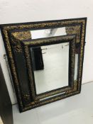 A C19TH DUTCH MIRROR IN C17TH STYLE - THE EBONISED FRAME APPLIED WITH DECORATIVE BRASS WORK 84 X