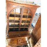 A GLAZED BOOK CASE WITH ARCHED DOORS AND CABINET BELOW A/F CONDITION