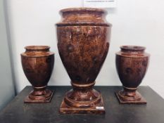 A LARGE PAIR OF BROWN GLAZED VASES AND ONE MATCHING LARGER,