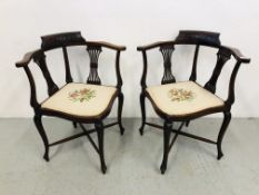 A PAIR OF MAHOGANY CORNER CHAIRS WITH STRUNG BACKS THE SEATS WITH EMBROIDERED DESIGNS