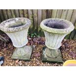 A PAIR OF STONEWORK GARDEN URNS