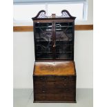 A GEORGE III MAHOGANY BUREAU BOOKCASE HAVING A FRETTED PEDIMENT ABOVE DOUBLE ASTRAGAL GLAZED DOORS,