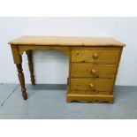 A HONEY PINE THREE DRAWER SINGLE PEDESTAL DRESSING TABLE/DESK