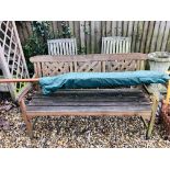 A HARDWOOD GARDEN COMPANION SEAT WITH PARASOL AND HARDWOOD GARDEN BENCH