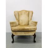 A C19TH WALNUT WINGED ARMCHAIR, THE FRONT LEGS SHELL CARVED,