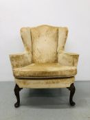 A C19TH WALNUT WINGED ARMCHAIR, THE FRONT LEGS SHELL CARVED,