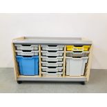 A WHEELED UNIT CONTAINING 12 PLASTIC STORAGE DRAWERS SIZE L102cm, H65cm,