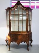 A C20TH DUTCH WALNUT CHINA CABINET OF CANTED FORM,