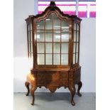 A C20TH DUTCH WALNUT CHINA CABINET OF CANTED FORM,