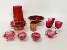 A GROUP OF CRANBERRY GLASSWARE TO INCLUDE THREE CUPS, JUG, SMALL BASKET WITH WIREWORK HANDLE,