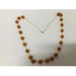 STYLISH LADIES CHAIN MARKED 375 (9CT) SET WITH AMBER TYPE BEADS L 77CM