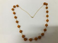 STYLISH LADIES CHAIN MARKED 375 (9CT) SET WITH AMBER TYPE BEADS L 77CM