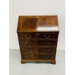 A REPRODUCTION MAHOGANY FINISH FOUR DRAWER WRITING BUREAU