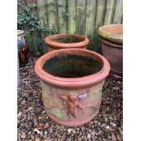 A PAIR OF TERRACOTTA GARDEN PLANTERS WITH CHERUB DESIGN