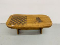A HARDWOOD COUNTRY CRAFTS STYLE COFFEE TABLE WITH HAND CARVED CHESS BOARD AND HORSE DESIGN TO TOP