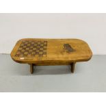 A HARDWOOD COUNTRY CRAFTS STYLE COFFEE TABLE WITH HAND CARVED CHESS BOARD AND HORSE DESIGN TO TOP