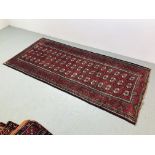 A BALUCHI RED AND BLUE PATTERNED CARPET 2.25 x 1.02. 1.