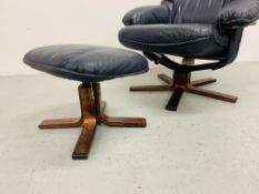 A NAVY BLUE LEATHER RELAXER CHAIR AND MATCHING FOOT STOOL