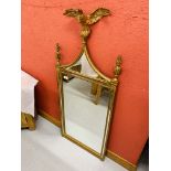 A REPRODUCTION GILT FINISH WALL MIRROR SURMOUNTED WITH EAGLE DESIGN