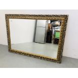 A MODERN ORNATE GILT FRAMED RECTANGULAR WALL MIRROR. W 105CM. H 74CM.